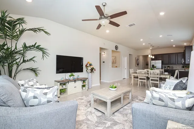a living room with furniture and a flat screen tv