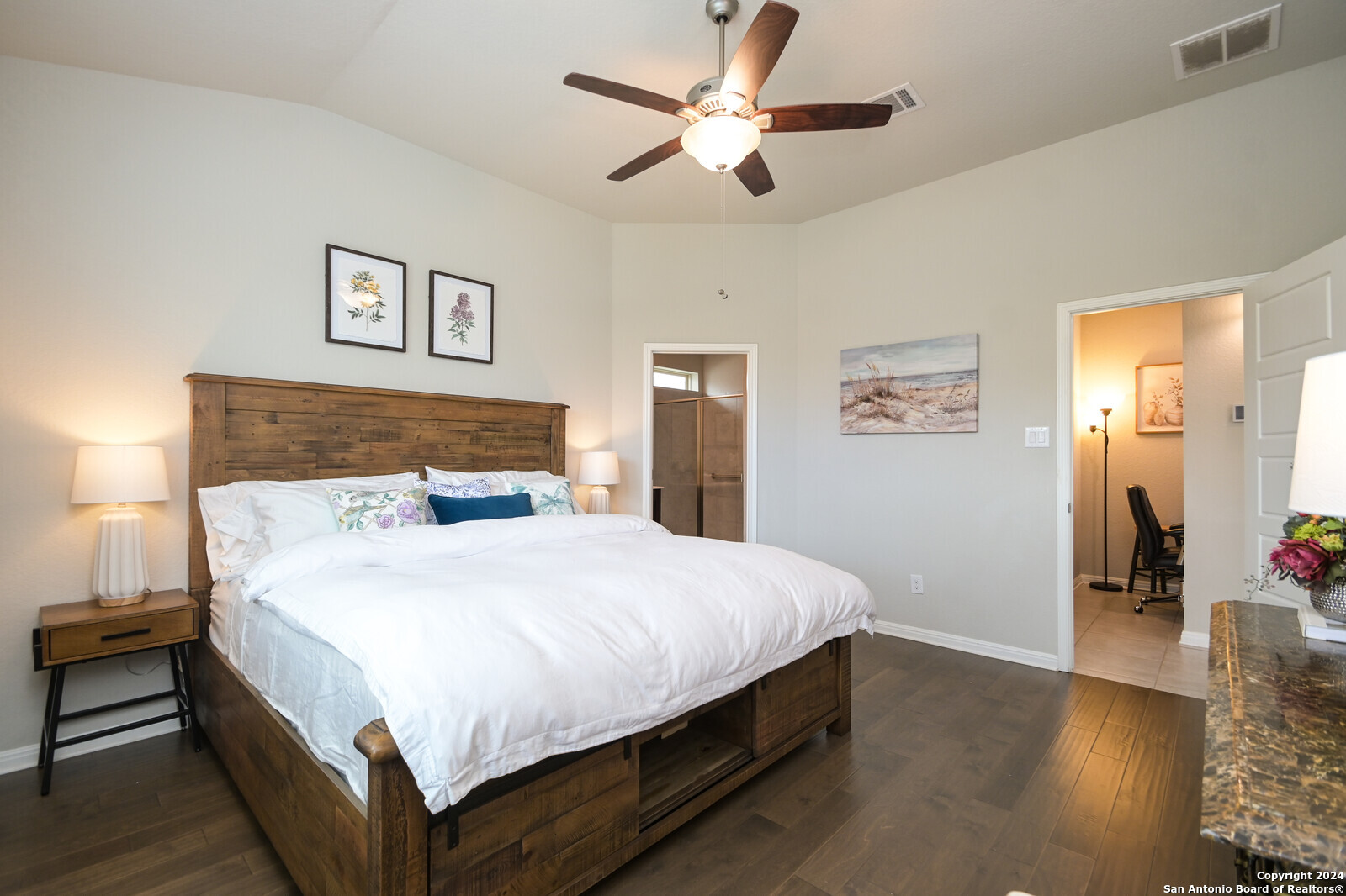 2411 Verona Way San Antonio, TX 78259 - Photo 17 of 22 a bedroom with a large bed and a chandelier