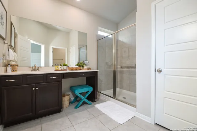 a bathroom with a sink mirror and a toilet
