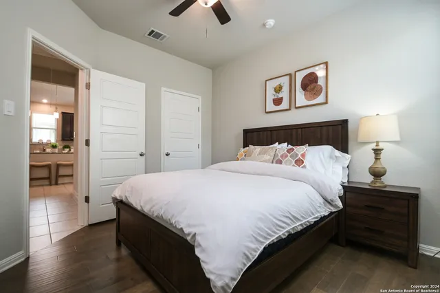 a bedroom with a bed and a chandelier