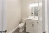 a bathroom with a sink a toilet and a mirror