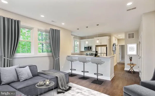 a living room with furniture and a large window