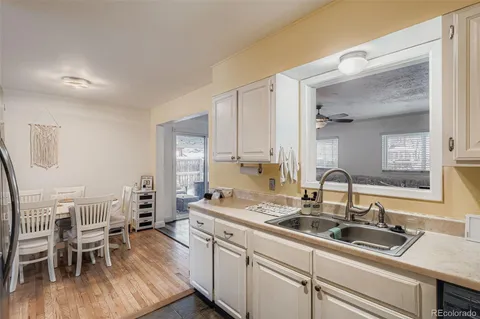 a kitchen with a sink and chairs