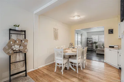 a dining room with furniture and wooden floor