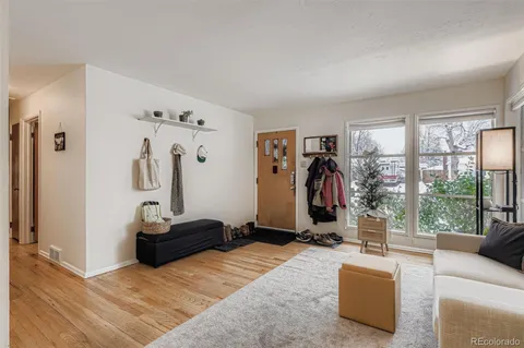 a living room with furniture a window and gym equipment