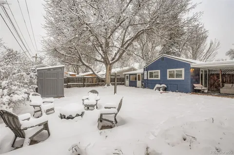 a front view of a house with a yard covered in snow