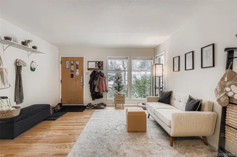 a living room with furniture a window and a flat screen tv