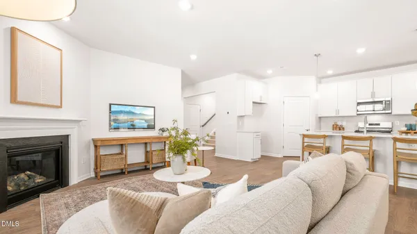 a view of kitchen with cabinets stainless steel appliances dining table and chairs
