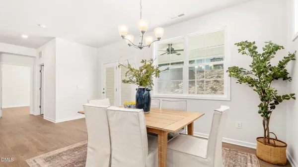 a living room with furniture fireplace and dining table