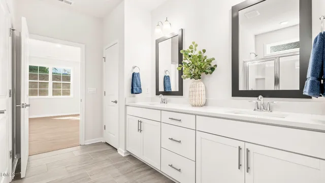 a bathroom with a double vanity sink and a mirror
