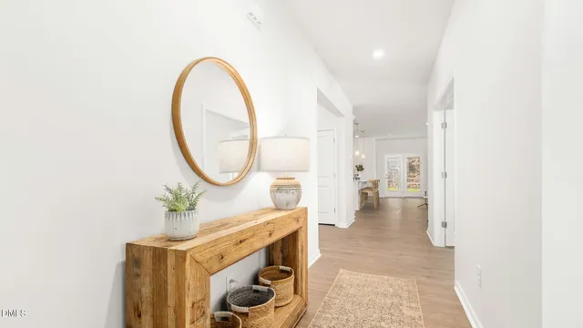 a bathroom with a sink a toilet a mirror a bathtub and shower