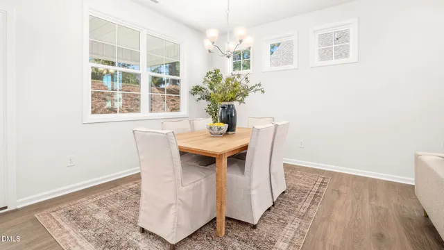 a living room with furniture a fireplace and a potted plant
