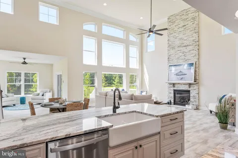a living room with furniture and floor to ceiling windows