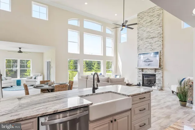 a living room with furniture and floor to ceiling windows