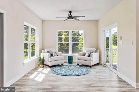 a living room with furniture and kitchen view