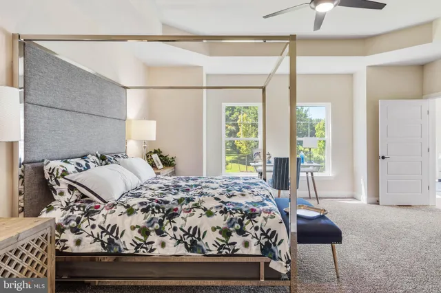 a living room with furniture and a ceiling fan