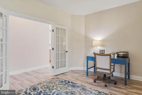 a kitchen with kitchen island granite countertop a sink and refrigerator