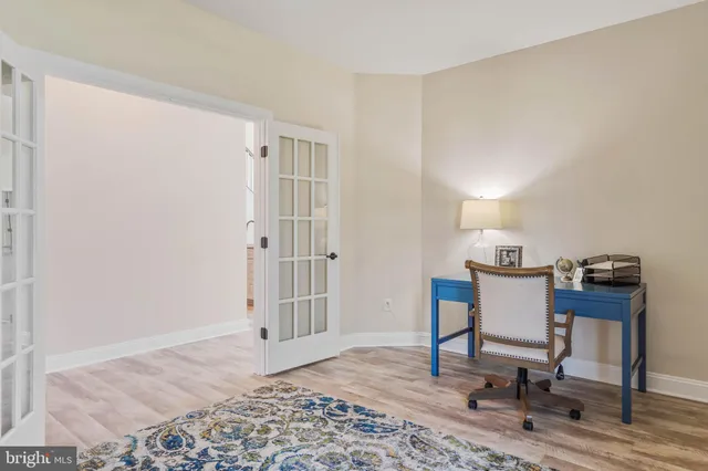a kitchen with kitchen island granite countertop a sink and refrigerator