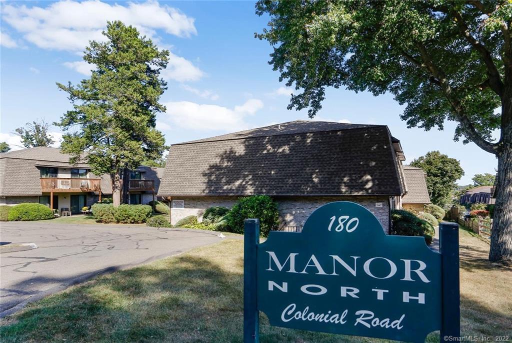 180 Colonial Road, Unit C8 Stamford, CT 06906 - Photo 1 of 1 a view of a street sign under a large tree