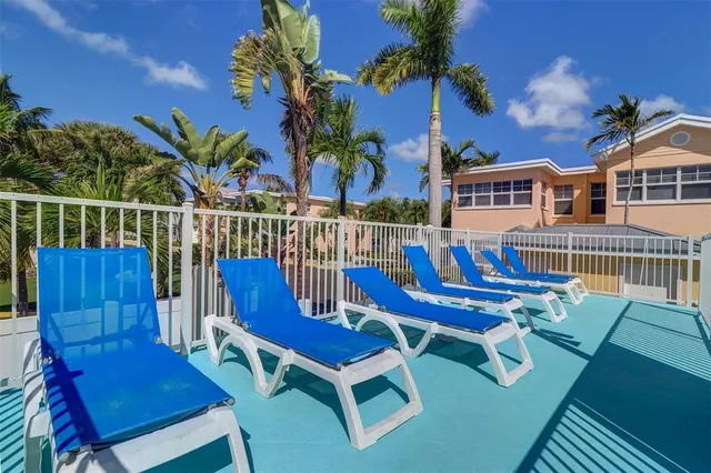 a view of a chairs and table on the deck