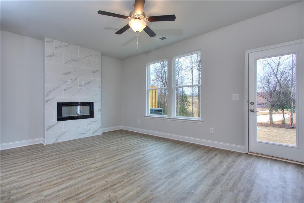 115 Greenview Court Homer, GA 30547 - Photo 12 of 32 a view of an empty room with wooden floor and a window