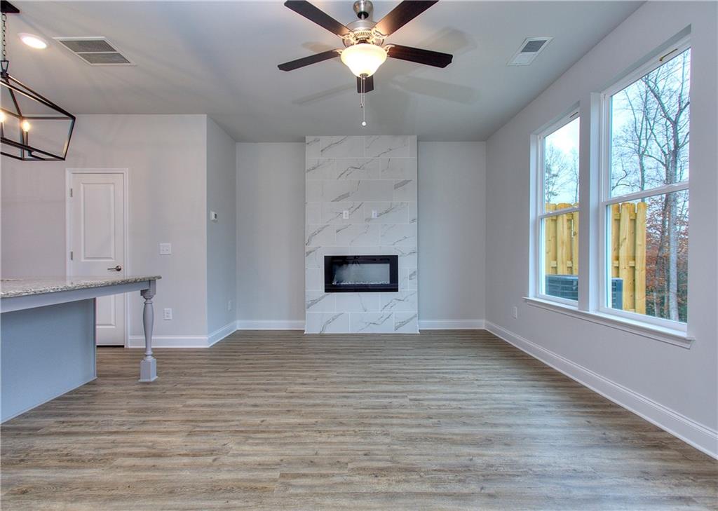 115 Greenview Court Homer, GA 30547 - Photo 13 of 32 a view of an empty room with a window and wooden floor