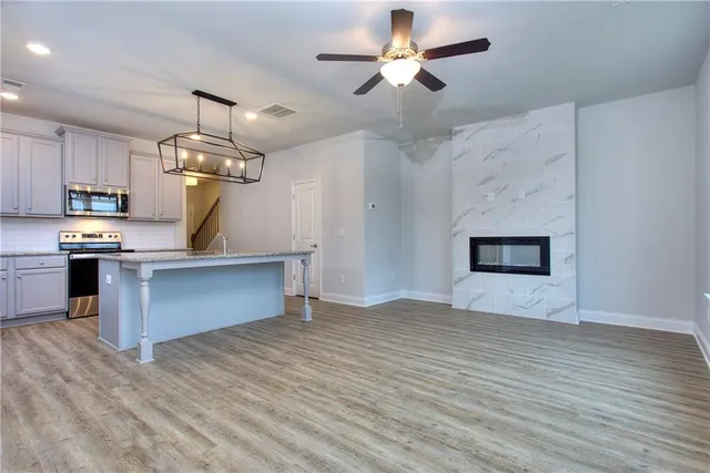 a view of kitchen with sink and refrigerator