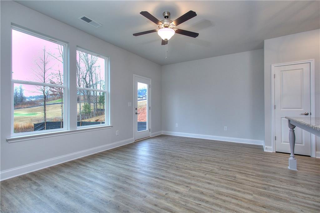 115 Greenview Court Homer, GA 30547 - Photo 17 of 32 a view of an empty room with a window and wooden floor