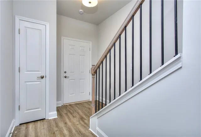 a view of a hallway with wooden floor and entryway