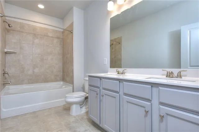 a bathroom with a double vanity sink toilet mirror and shower