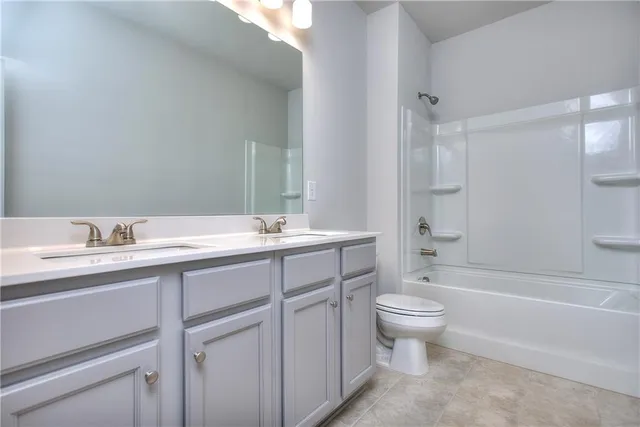 an empty room that has a grey walls