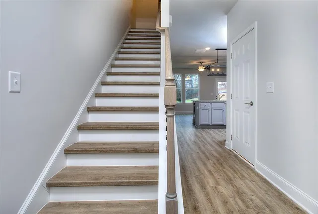 a view of entryway and hall with wooden floor