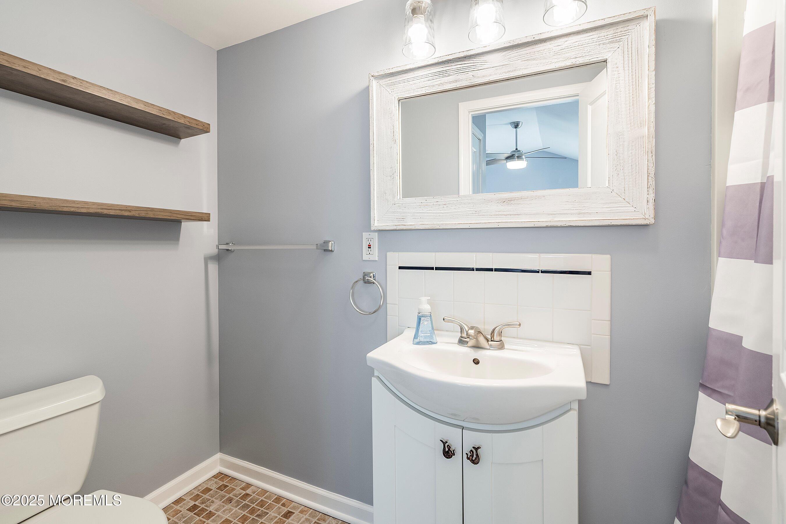 309 Hiering Avenue, Unit A Seaside Heights, NJ 08751 - Photo 13 of 18 a bathroom with a toilet sink and mirror