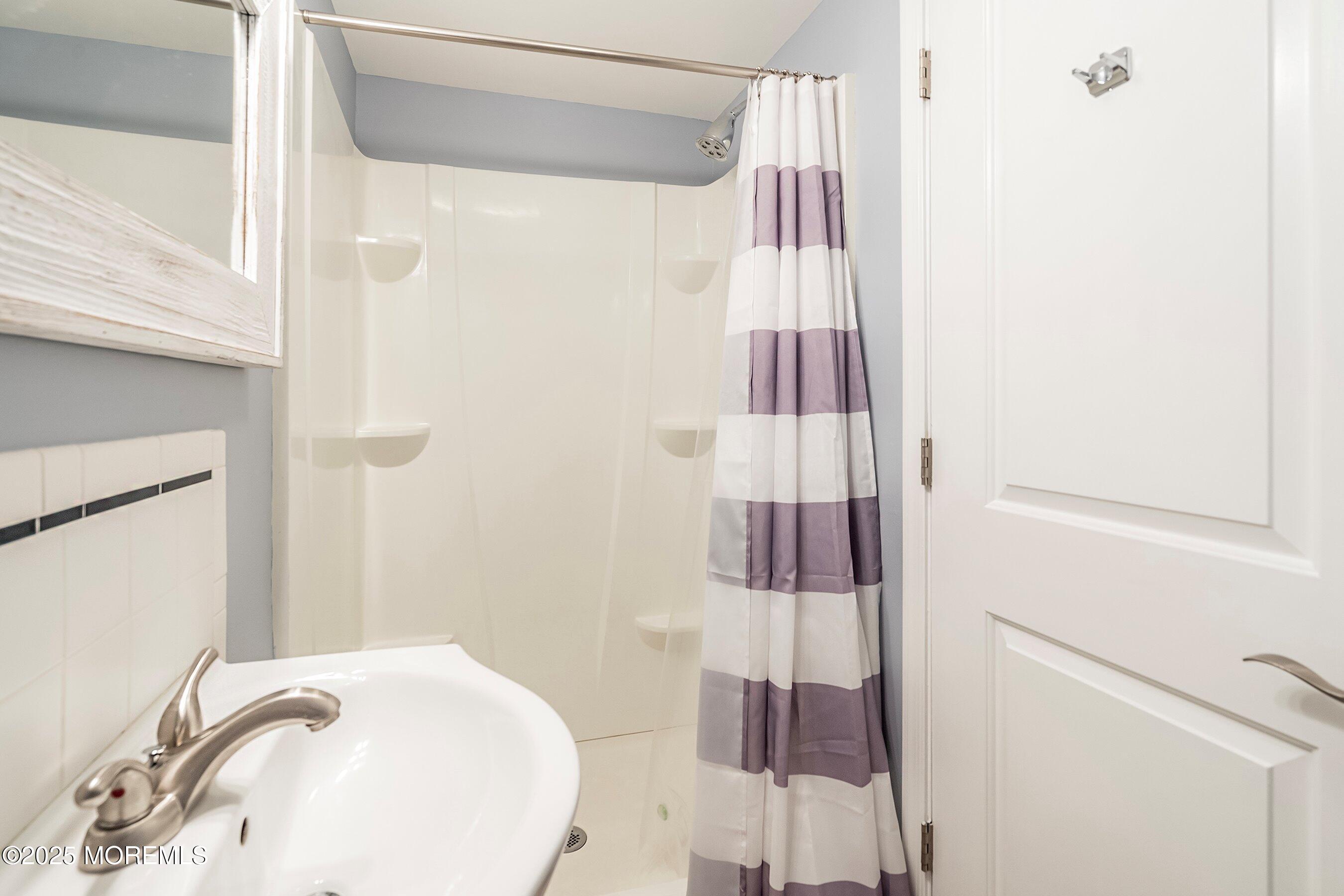 309 Hiering Avenue, Unit A Seaside Heights, NJ 08751 - Photo 14 of 18 a bathroom with a sink and a mirror