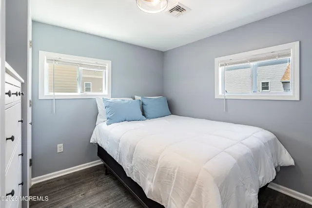a large bed sitting in a bedroom next to a window