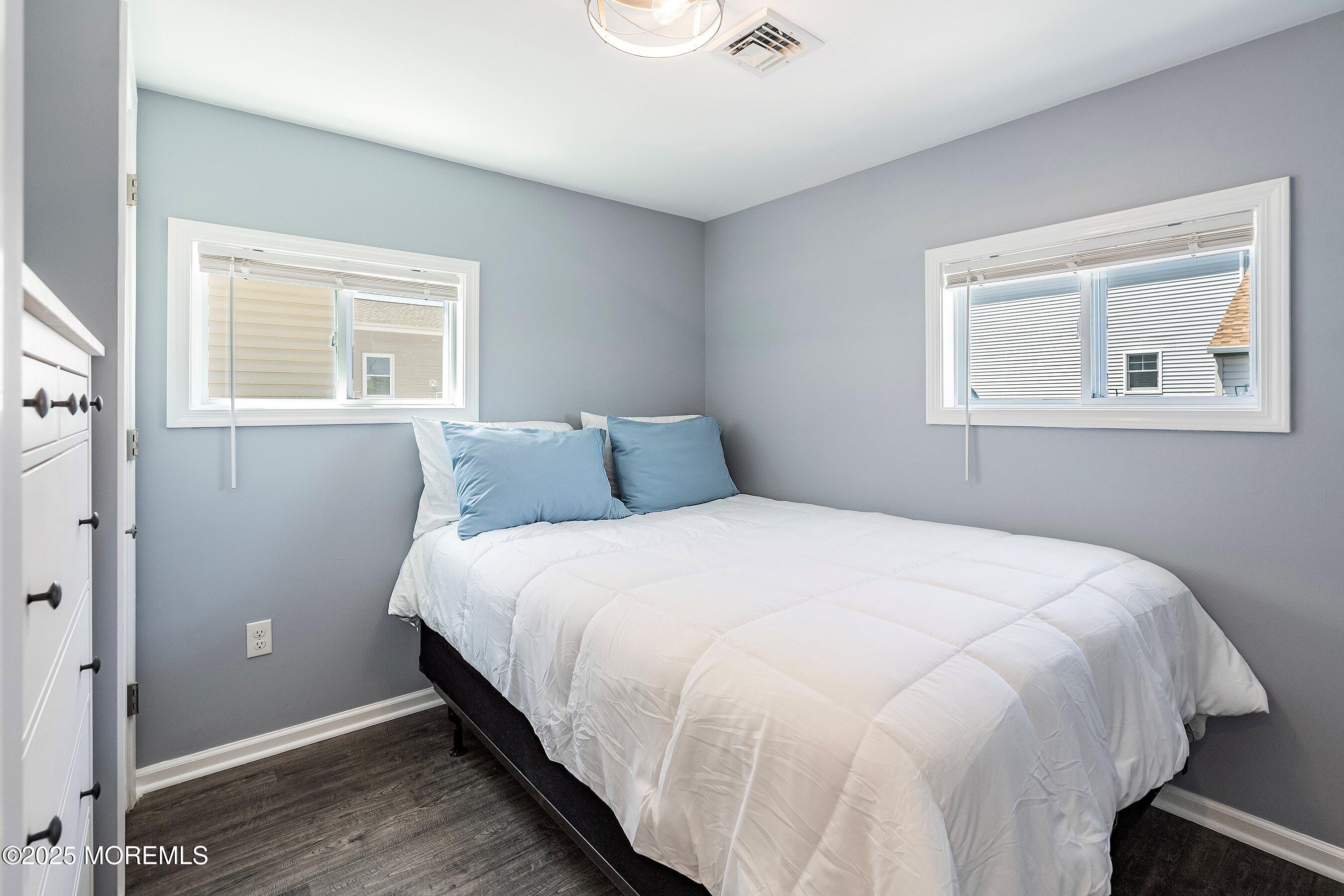 309 Hiering Avenue, Unit A Seaside Heights, NJ 08751 - Photo 17 of 18 a large bed sitting in a bedroom next to a window