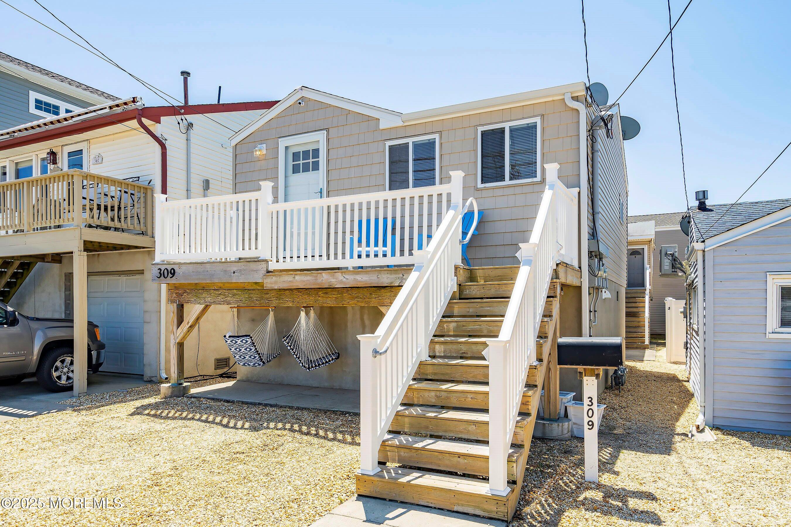309 Hiering Avenue, Unit A Seaside Heights, NJ 08751 - Photo 18 of 18 a view of a house with wooden deck