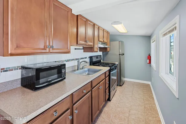 a kitchen with a sink stove and cabinets