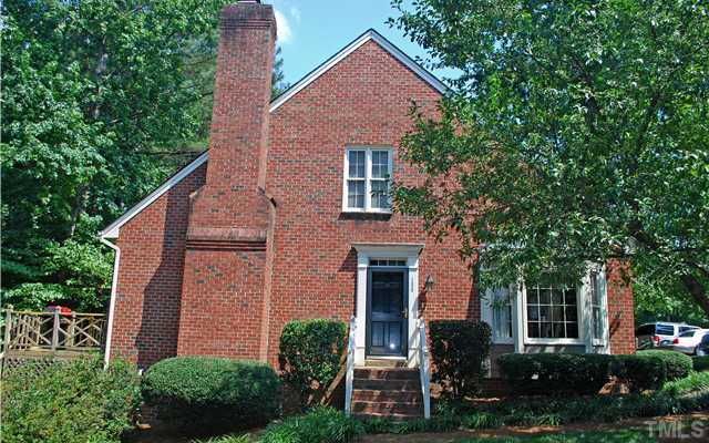 1306 Hampshire Court Raleigh, NC 27612 - Photo 11 of 12 a front view of a house with plants and trees