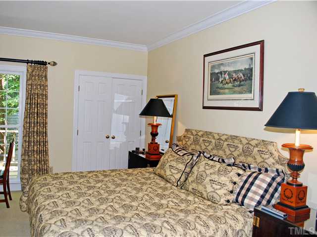 1306 Hampshire Court Raleigh, NC 27612 - Photo 3 of 12 a bedroom with a bed and a lamp on dresser