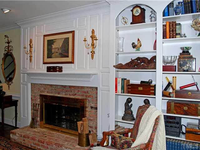 1306 Hampshire Court Raleigh, NC 27612 - Photo 6 of 12 a living room with a fireplace and a wooden floor