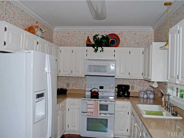 1306 Hampshire Court Raleigh, NC 27612 - Photo 7 of 12 a kitchen with stainless steel appliances granite countertop a refrigerator sink and stove