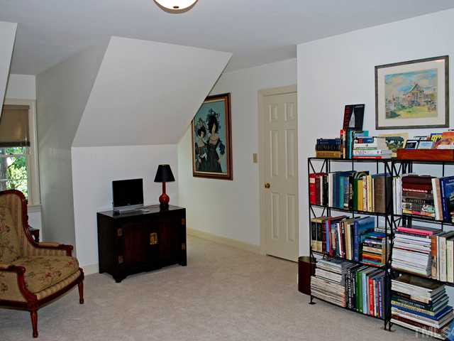1306 Hampshire Court Raleigh, NC 27612 - Photo 9 of 12 a living room with lots of furniture and baby bed
