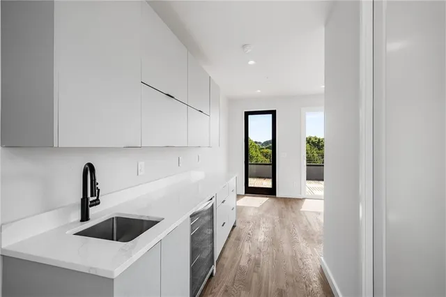 a kitchen with granite countertop a sink and a stove