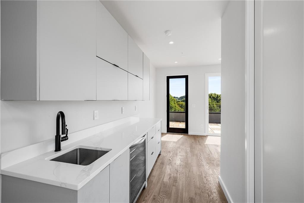 105 Georgia Avenue Southeast, Unit 8 Atlanta, GA 30312 - Photo 17 of 33 a kitchen with granite countertop a sink and a stove