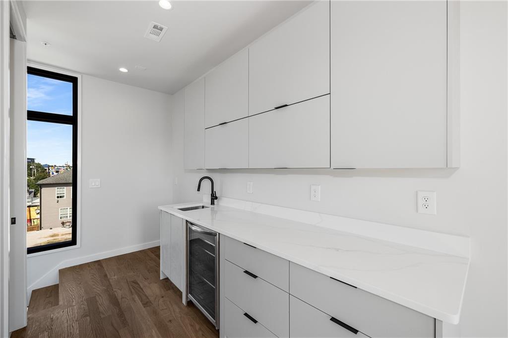 105 Georgia Avenue Southeast, Unit 8 Atlanta, GA 30312 - Photo 18 of 33 a kitchen with a sink cabinets and a wooden floor