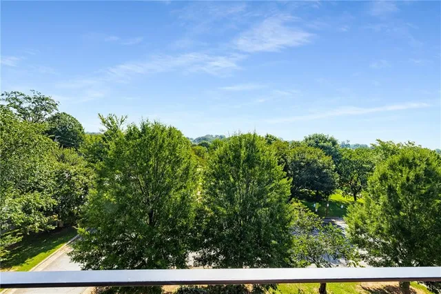 a view of a field of grass and trees