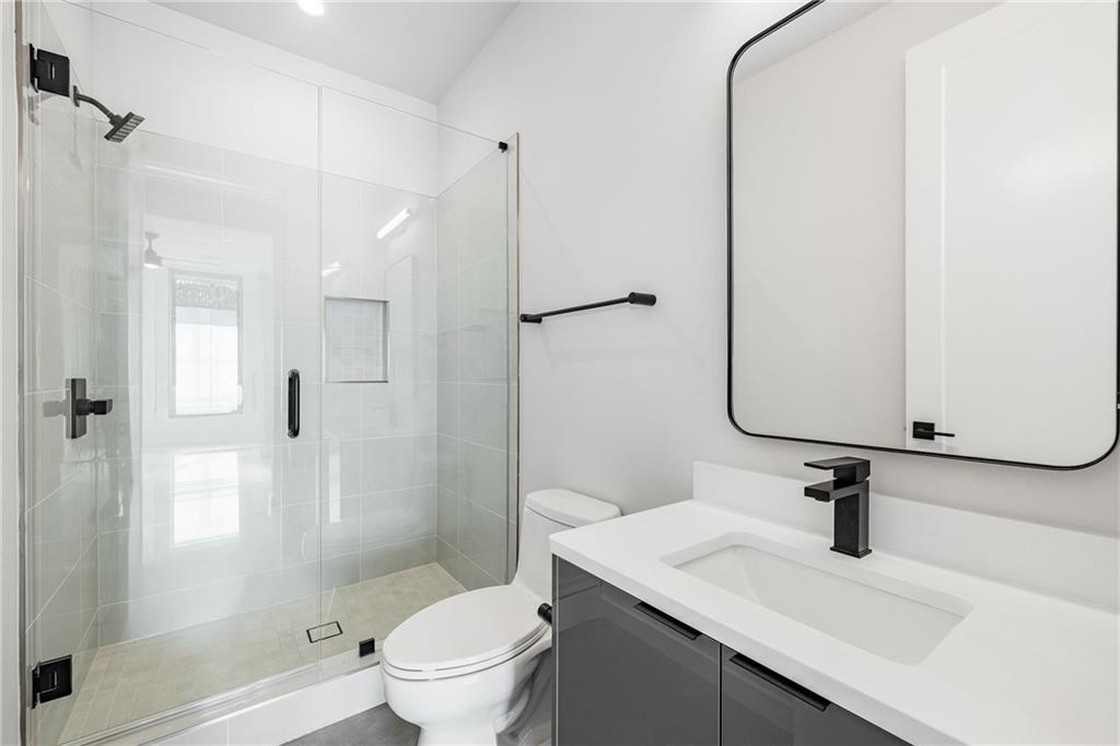 105 Georgia Avenue Southeast, Unit 8 Atlanta, GA 30312 - Photo 26 of 33 a bathroom with a sink a toilet and shower