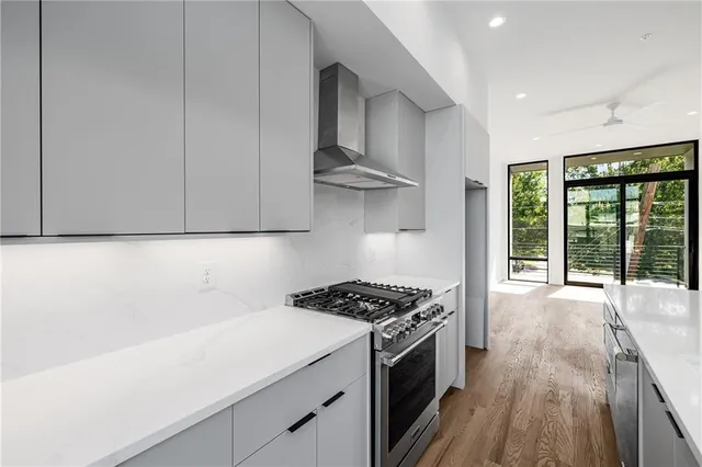 a kitchen with stainless steel appliances a cabinets and a stove top oven