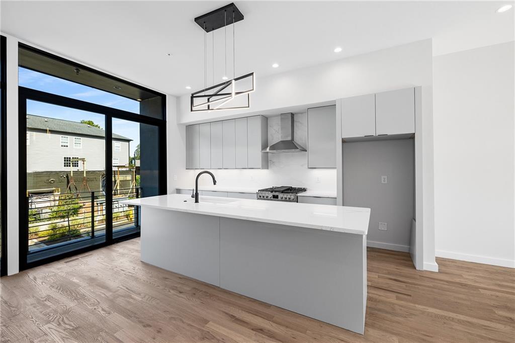 105 Georgia Avenue Southeast, Unit 8 Atlanta, GA 30312 - Photo 5 of 33 a kitchen with stainless steel appliances a sink a stove and a refrigerator